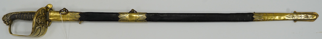 A Victorian warrant officer's sword by Westcott and Sons, regulation brass hilt, black fish skin covered grip, in its brass mounted leather scabbard, blade 79.5cm. Condition - well worn